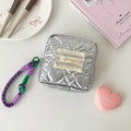 Detail of silver quilted makeup bag with heart pattern and woven handle for storage - Purple
