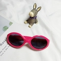 Pink silicone polarized children's sunglasses with dark grey lenses on white fabric - Rose Red