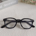 Retro square sunglasses with gray striped frames and clear lenses in a lifestyle setting - Grey 16-Black Grey Striped Acetate Frame