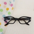 Kids vintage black cat-eye sunglasses with silver metal decor on textured white backdrop - Black Frame Clear Lenses