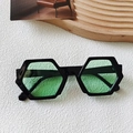 Fashionable black hexagonal sunglasses with transparent green lenses on a tray - Black Frame Green Lens