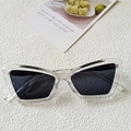 Retro cat-eye sunglasses with transparent frames and dark lenses on a textured background - Clear