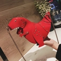 Detail of red dinosaur crossbody bag with golden rivet accents and metallic chain strap - Red