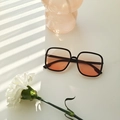 Fashionable black square sunglasses with gradient orange-brown lenses on white surface - Blush Gradient (2221)