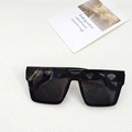 Oversized matte black square sunglasses with dark grey lenses in a minimalist flat lay setting - Black and Gray