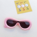 Pink chunky oval sunglasses with dark lenses and retro thick frame on white texture - Pink