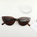 Retro amber cat-eye sunglasses with dark brown lenses on a textured white background - Dark Tea