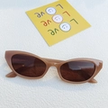 Retro cat-eye sunglasses with transparent brown frames and dark lenses on white background - Jelly Tea