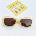 Retro cream beige cat-eye sunglasses with dark brown lenses on a textured background - Light Yellow