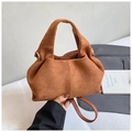 Detailed view of brown suede handbag featuring soft texture and gold circular metal hardware - Brown