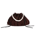 Dark brown pleated cloud bucket bag featuring large white pearl handle and drawstring - Brown
