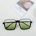 Square black sunglasses with green gradient lenses on a minimalist white backdrop - Black Frame Green Lens