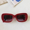 Retro red wide-frame rectangular sunglasses with dark gradient lenses on white texture - Burgundy