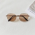 Close-up of retro gold metal kids' sunglasses with amber lenses and black temple tips - Light Tea