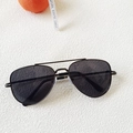 Detail shot of kids metal aviator sunglasses with dark lenses on a white textured background - All Grey (B161)