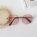 Close-up of hexagonal pink lenses and silver metal frame of stylish kids' sunglasses - Pink