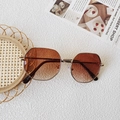 Macro view of gold metal frame sunglasses with gradient brown polygon lenses - Double Tea