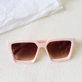 Detailed close-up of square pink frames and gradient brown lenses on white texture - Pink