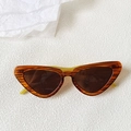 Detail view of retro cat eye sunglasses with amber frames and unique green temples - Amber Frame Green Temples
