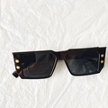 Detail of black rectangular sunglasses featuring golden B-logo metal studs on the frame - Dark Grey