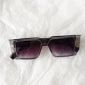 Detail view of transparent grey square sunglasses with gradient purple lenses and B studs - Smoke Gray