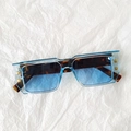 Detail of square sunglasses with blue transparent frame and golden B logo on temples - Transparent Blue