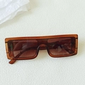 Close-up of vintage oversized orange rectangle sunglasses with brown tinted lenses - Transparent Dark Tea
