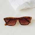 Detail of retro tortoiseshell square sunglasses with brown gradient lenses on white texture - Leopard Print