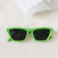 Flat lay of retro neon green square sunglasses with dark lenses on a white textured surface - Green-Gray
