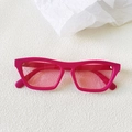 Detail of trendy rose pink cat-eye sunglasses with translucent lenses on white textured surface - Rose Pink Lens