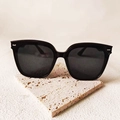 Classic large black frame sunglasses with silver rivet accents on a textured stone base - Horizontal Rice Nails