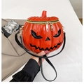 Detail of a bright orange pumpkin shoulder bag with dual gold zippers and glossy finish - Orange