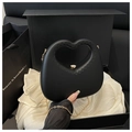 Detailed view of black heart-shaped handbag with gold chain in a premium gift box - Black