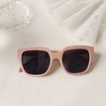 Detail of pink square sunglasses with matte frame on aesthetic textured surface - Rose Pink