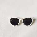 Detail of white round sunglasses showing UV400 protection and CE certification mark - White