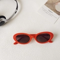 Retro red oval sunglasses with dark brown lenses and silver dot accents on frame - Orange