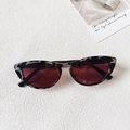 Close-up of tortoise shell cat-eye sunglasses with silver diamond metal decorations - Beige Tortoiseshell