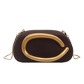 Detail of elegant dark brown evening bag with a bold gold C-shaped metal handle and chain - Coffee
