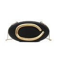 Elegant black oval evening bag featuring a distinctive gold C-shaped metal handle and chain - Black