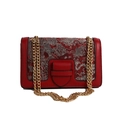Retro red crossbody bag with silver embroidery and golden chain strap in a front view - Red