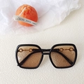 Kids black oval UV400 sunglasses featuring a decorative golden horsebit buckle link - Black Frame Champagne Lens