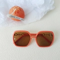 Kids oval UV400 sunglasses in translucent amber orange with gold horsebit detail - Orange