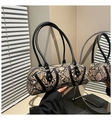 Detail of faux snake print texture and cylindrical shape on this fashion shoulder bag - One Size / Khaki