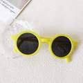 Vibrant yellow round sunglasses for kids with dark lenses in a minimalist setting - Small Round Frame Yellow