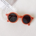 Retro round matte orange kids sunglasses with dark grey lenses on white background - Small Round Frame Orange