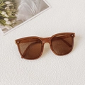 Retro amber oversized sunglasses for toddlers featuring brown lenses and floral background - One-Dot Tea Brown