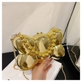 Macro detail of golden bow-shaped evening clutch bag with metallic mirror finish and bead chain - Mirror Gold / Bead Handle Style