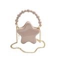 Star-shaped crossbody bag in soft pink featuring a beaded handle and gold chain strap - Khaki
