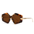Oversized tortoise shell hexagonal sunglasses with gold metal temples on white background - Leopard Frame / Tea Lens