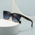 Square butterfly sunglasses in black and amber with blue gradient lenses on a white base - Black to Amber Gradient Frame / Blue Lens